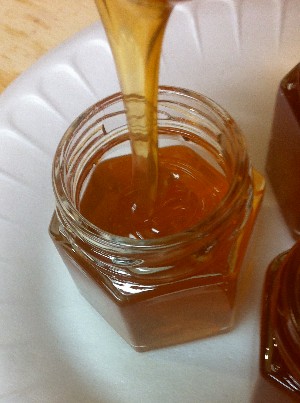 honey dripping into jar